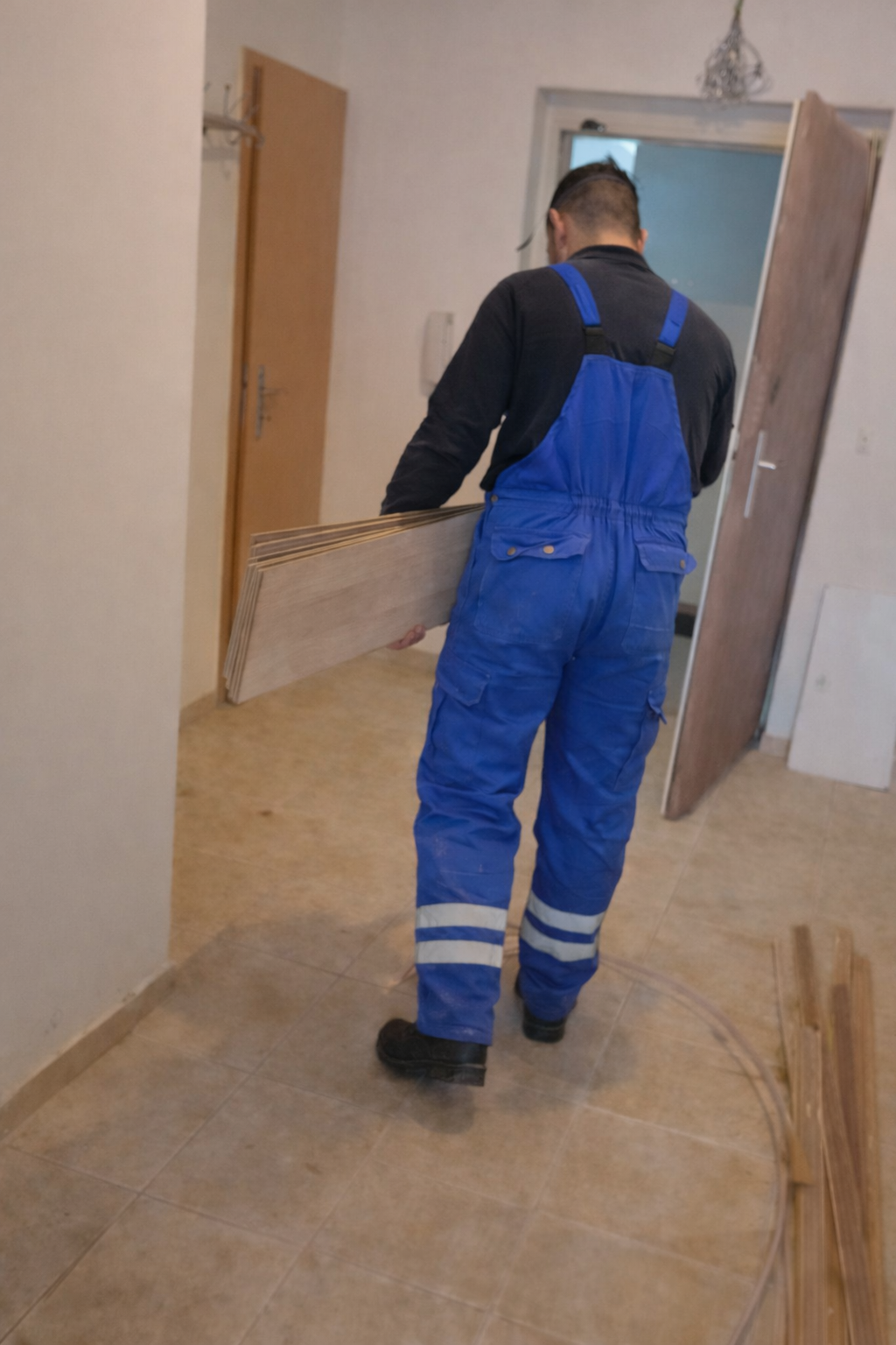 pracovník nese prkna v interiéru